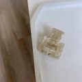Detailed close-up of a handmade cream marble mini hair claw clip on a white tray - Off White