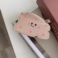 Detailed macro view of cheese-shaped hair claw with cute cartoon face and tiny 3D bear accessory - Lotus root pink