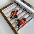 Detail view of cartoon dog hair clip in red Tang suit with golden metal duckbill clamp - Tang Suit Border Collie Duckbill Clip