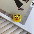 Close-up of cute yellow monster acetate hair claw clip with marble texture detail - Yellow