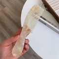 Macro shot of acetic acid hair comb with elegant pearlescent marble texture and wide teeth - Transparent Yellow