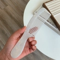 Detail of pearlescent white acetate hair comb with elegant marble texture in hand - White Enamel