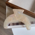 Macro shot of large crescent acetate hair claw clip with creamy marble pearl finish - Light Yellow Marble Moon Claw