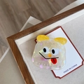 Macro shot of colorful acetate hair claw with cute cartoon monster face on display - White Tongue-out Monster