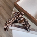 Detail of large acetate hair claw with brown and pink marbled pattern on wood - Coffee Marble Moon Claw