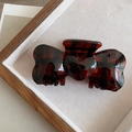 Detail view of red plaid acetate hair claw clip with heart ornament in wooden box - Heart Bow Tie Claw Clip