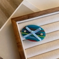 Detail of acetate bow hair clip with multi-color stripes and crystal rhinestone accents - Blue Bow Side Clip
