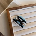 Detail of blue striped acetate hair clip with black ribbon bow and small crystals - Black Bow Side Clip