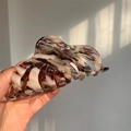 Close-up of large acetate claw clip featuring mixed marble texture in brown and purple - Purple And White Textured (L1-022CL)