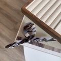 Detail of large acetate hair claw clip featuring stylish brown and white marble textures - Ink Marble