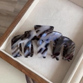 Détail de la pince à cheveux en acétate écaille de tortue avec des reflets bleus nacrés - Marbre à l'Encre
