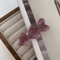 Detail of pink heart-shaped hair clip with three stacked resin hearts on silver metal base - Purple