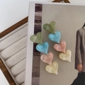 Close-up of heart-shaped hair clips with colorful acetate material on a fashion magazine - Multicolor