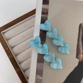 Detail of light blue marble textured heart hair clips on a lifestyle background - Blue