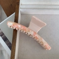 Detailed macro view of the marble-textured acetate hair claw clip with pink matte finish - Rice Pink