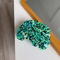 Close-up of handmade elephant acetate hair claw with green mosaic patterns and gold logo - Forest Green Elephant Claw