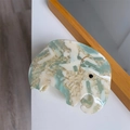 Detail of elephant-shaped acetate hair claw with marble texture and handmade mark - Cream And Green Elephant Claw