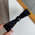 Macro detail of black bow hair clip featuring colorful rhinestones and glossy resin finish - Full Rhinestone Bow Spring Clip / Black