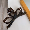 Detailed view of large acetate bow hair claw clip with classic tortoiseshell pattern - Retro Floral