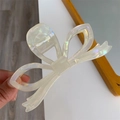Detail view of large acetate bow hair claw clip with iridescent pearly white finish - White Enamel