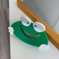 Detailed view of a cute green frog-shaped hair claw clip with a glossy acetate finish - Bright Green Frog Style