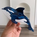 Close-up of a handmade orca whale hair claw clip featuring blue marble acetate texture - Dark Blue Shark