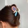 Sweet acetate hair claw with pastel patchwork and crystal star accents on brunette bun - Pink Beige and Light Blue