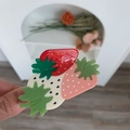 Detail view of pink and red strawberry hair claw clip made of glossy acrylic material - Pink Red White Strawberry