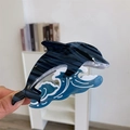 Détail de la pince à cheveux dauphin bleu en acétate avec une texture marbrée élégante - Pince à Cheveux Dauphin Bleu Jouant dans l'Eau