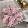 Dettaglio dell'elastico in pizzo rosa con perle e un'etichetta fatta a mano - Rosa