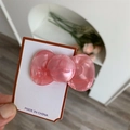 Detailed view of a pink acetate bow hair clip with marbled texture on a display card - Pink