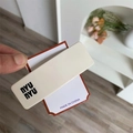 Close-up of a cream white rectangular hair clip with NYU NYU lettering detail - Creamy White Square