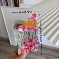 Conch shaped acetate hair claw in pink and green with blue rhinestones and size labels - Multicolor Conch Claw Clip