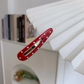 Close-up of red hair clip with white polka dots clipped on a white pleated lampshade - Water Drop Red Polka Dot / Small Water Drop Shape