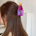 Detailed view of a purple juice bottle hair claw clip holding long brown hair securely - Purple Juice Bottle (L 9.8cm W 3.9cm Weight 26g)