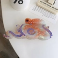Close-up of octopus hair claw clip in orange acetate with realistic suction cup details - White Large Octopus Claw