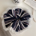 Detail van gestreepte gebreide scrunchie met witte franjes en zachte elastische textuur - Gestreepte Koffie
