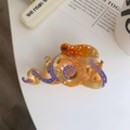 Detailed macro shot of an acetate octopus hair claw showing textured tentacles and suction cups - Orange Small Octopus Claw