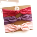 Three-pack cotton baby bow headbands in red, purple, and pink on display card - Red Dark Purple Light Pink