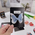 Détail d'une pince à cheveux papillon faite main avec paillettes bleues et violettes - Nœud Bleu Et Blanc
