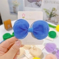 Gros plan détaillé d'une pince à cheveux à nœud en tulle bleu sur une carte mode - Bleu saphir