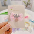 Close-up of pink tulle bow hair clip with silver crown rhinestone detail on display card - Hair Clip / Pink