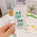 Close-up of handmade knit frog hair clips with pink ribbon wraps for children - Frog (Duckbill Clip)