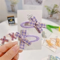 Set of two purple plaid fabric bow hair clips displayed on a white branded card - Purple Pink Houndstooth