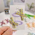 Close-up of set of two purple hair clips with yellow and grey plaid fabric bows - Purple and Yellow Checkerboard