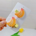 Detail of yellow glitter banana hair clips with pink floral accent and fabric lining - Banana Duckbill Clip