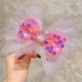 Close-up of pink sequin mesh bow hair clip with central pink gemstone and crystal details - Headband / Rose Pink