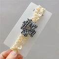 Lace baby headband featuring a black and white houndstooth flower with colorful beads - Black and White Plaid Style
