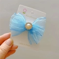 Detailed shot of a blue organza bow hair clip with a faux pearl and rhinestone center - Hair Clip / Blue