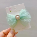Close-up of mint green tulle bow hair clip with faux pearl and rhinestone center detail - Hair Clip / Green